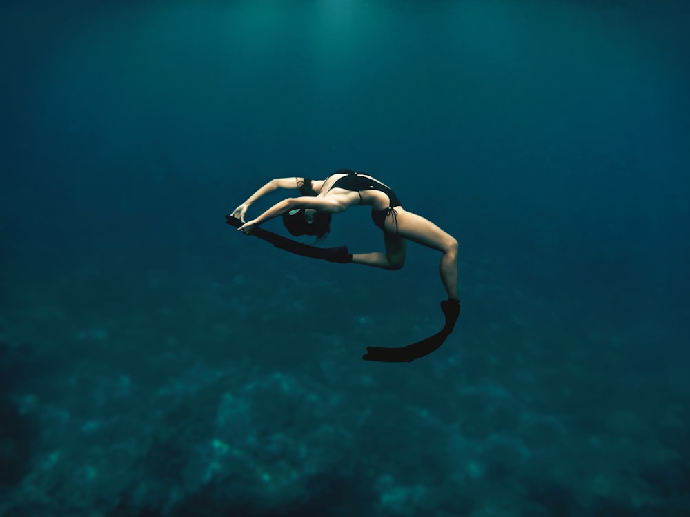 woman in black and white bikini swimming in the water