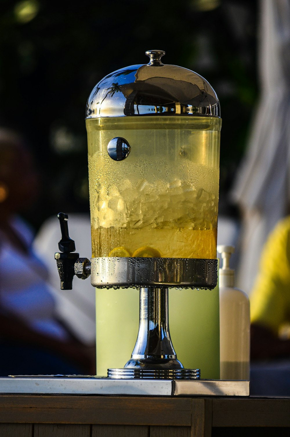 clear glass bottle with yellow liquid