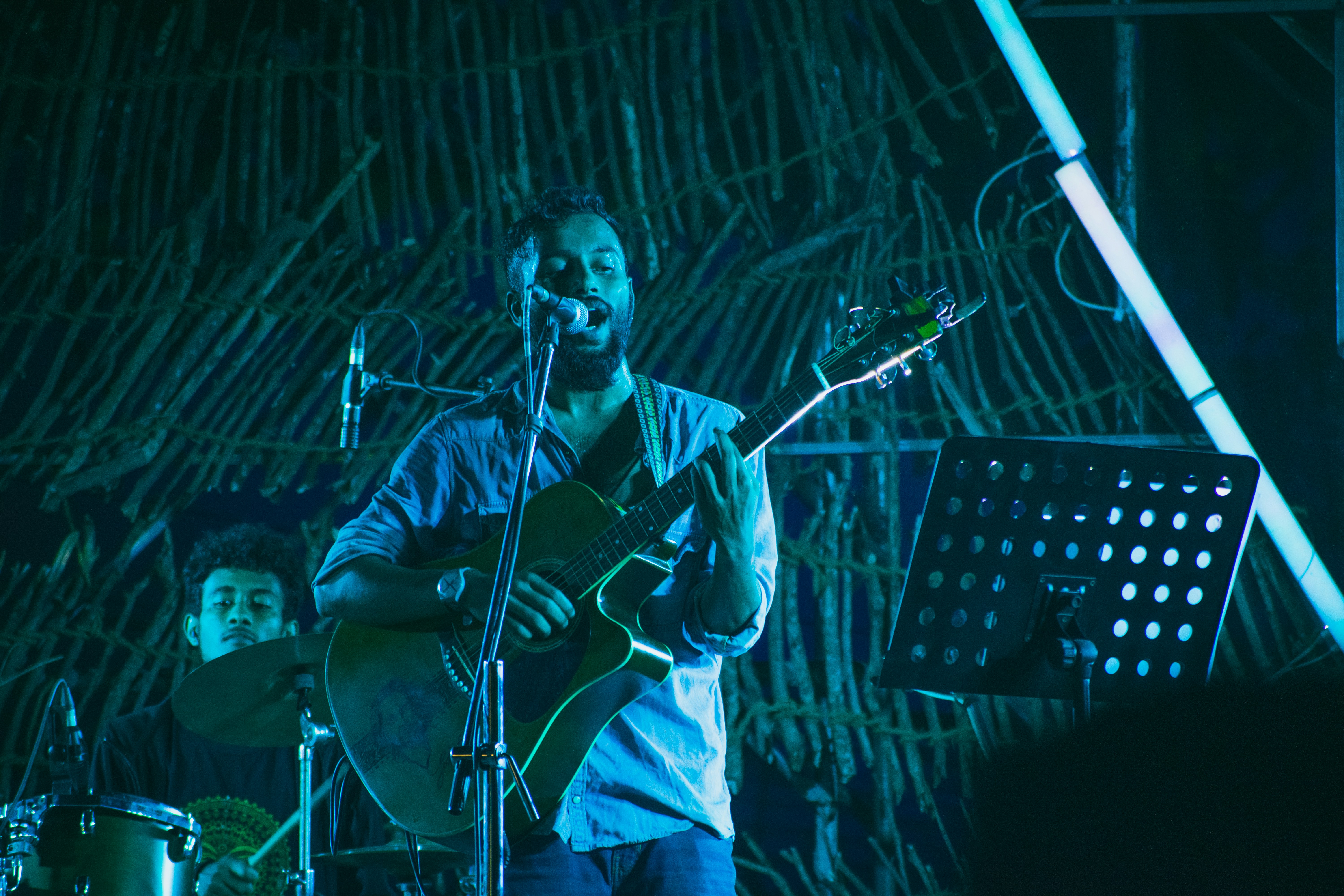 man in white dress shirt playing guitar