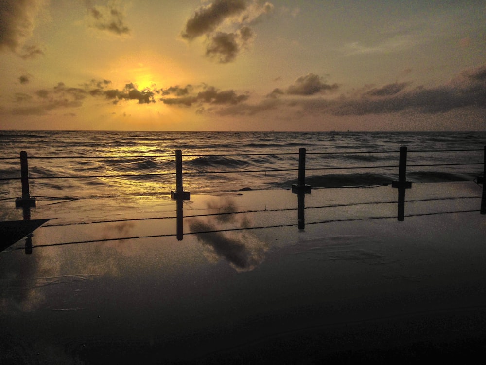 sea waves crashing on shore during sunset