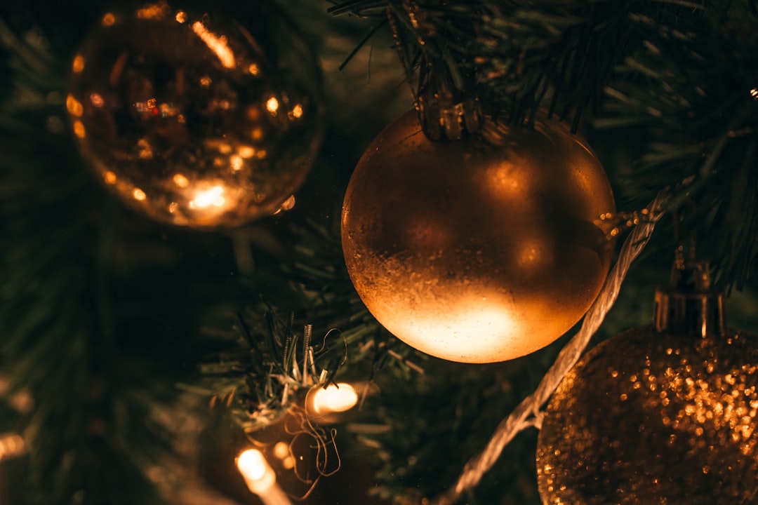 gold bauble on green christmas tree