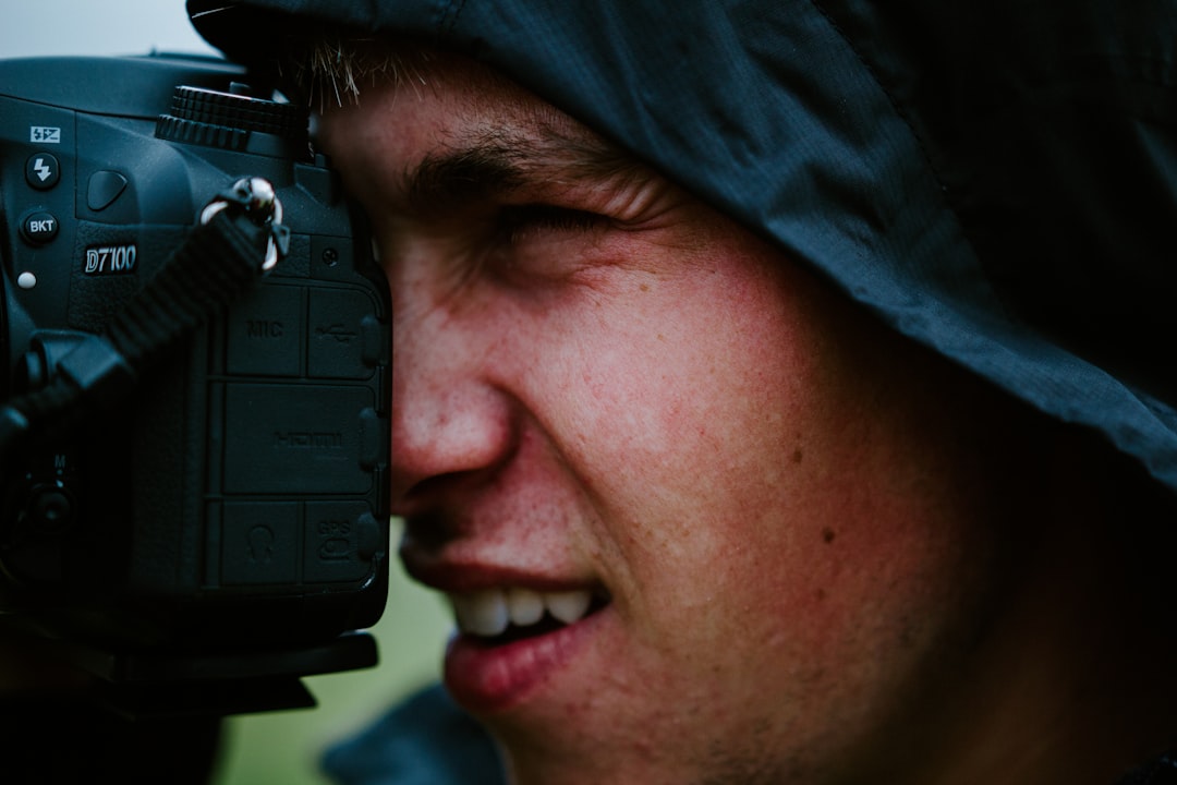 man in black shirt holding black camera