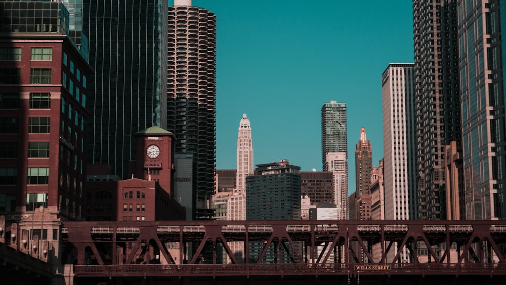 red bridge over city buildings during daytime