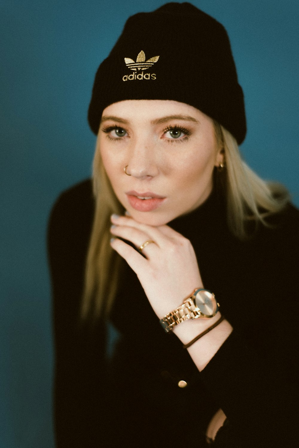 woman in black knit cap and gold ring