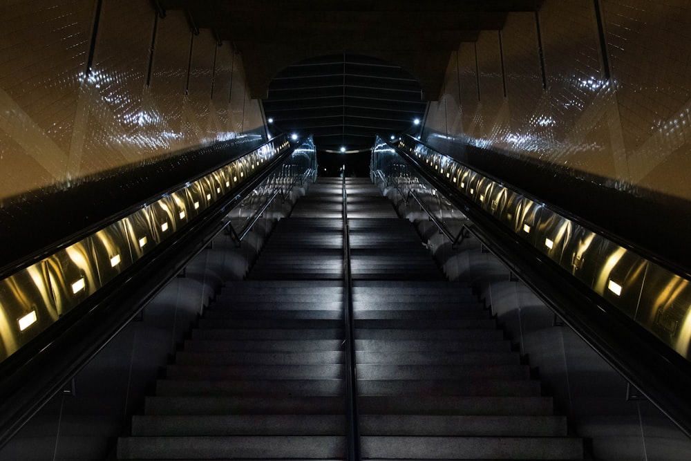 black and brown escalator in tunnel
