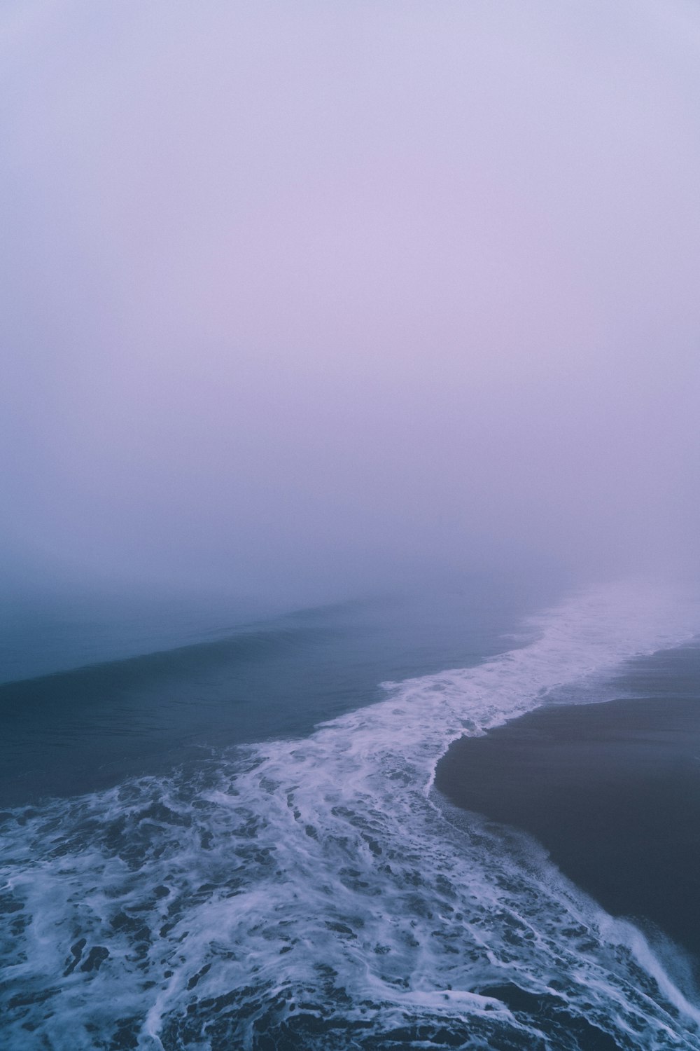 ocean waves crashing on shore during daytime