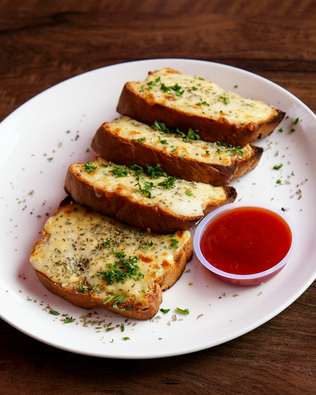 toasted bread with tomato sauce on white ceramic plate