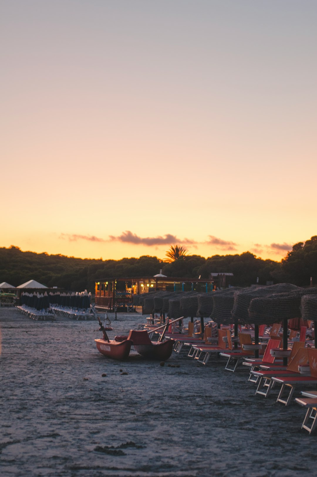 red wooden boat on sea during sunset