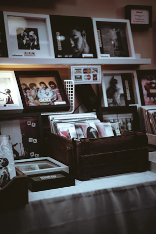 A cozy corner of Elmora Atelier showcasing a variety of framed vintage photographs and memorabilia.