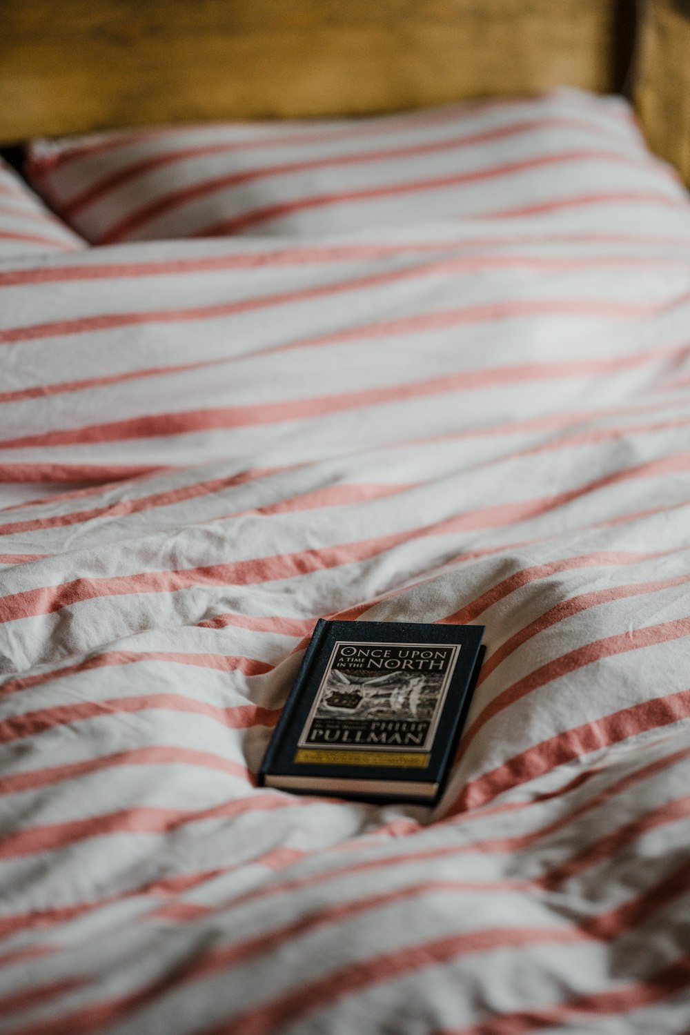 black and white playing card box on white and pink stripe textile