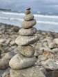 stack of gray and white stones near sea during daytime