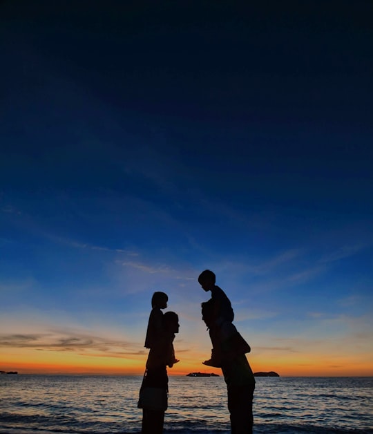 silhouette of man and woman kissing during sunset in Kundasang Malaysia