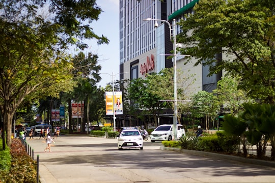 cars parked on sidewalk near building during daytime in Cebu IT Park Philippines