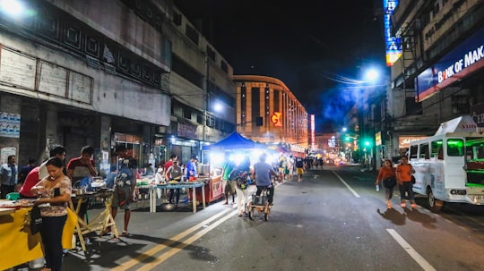 people walking on street during night time in Cebu Philippines