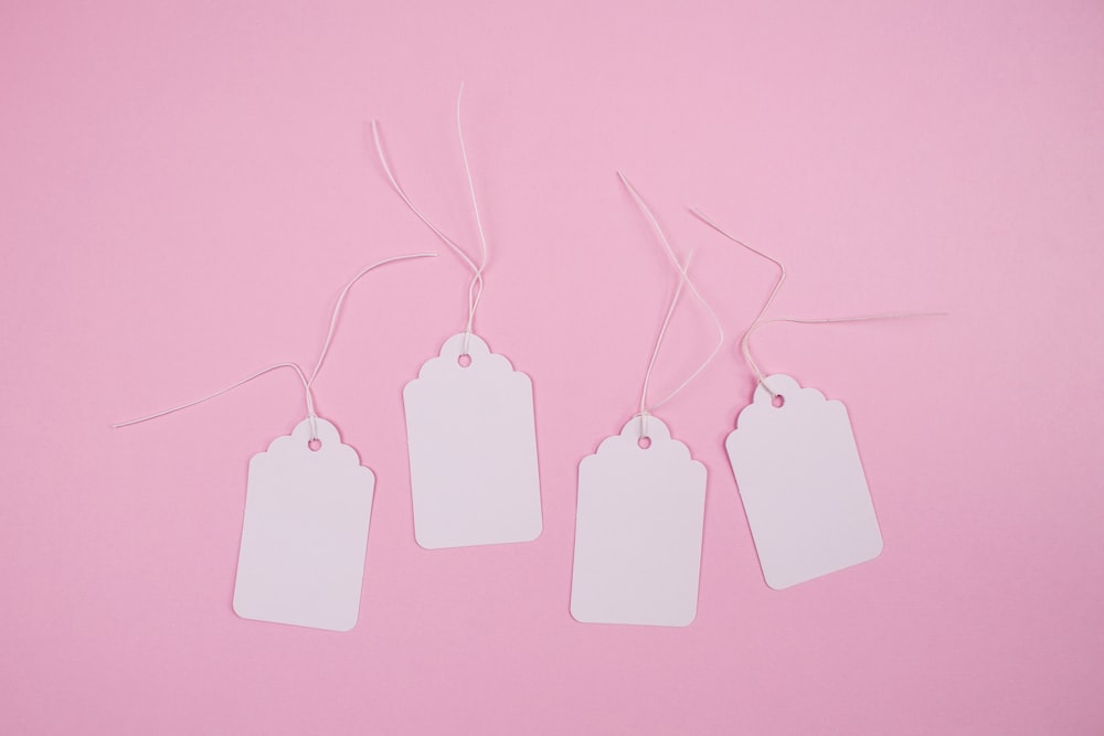 white apple earpods on pink surface