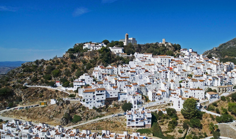 white concrete buildings on hill during daytime