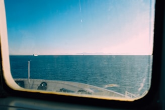 Scenic view of a modern ship sailing on the ocean under a clear blue sky.