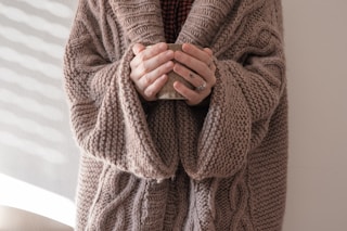 person in brown knit sweater