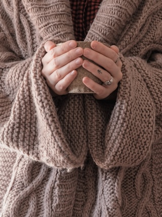 person in brown knit sweater