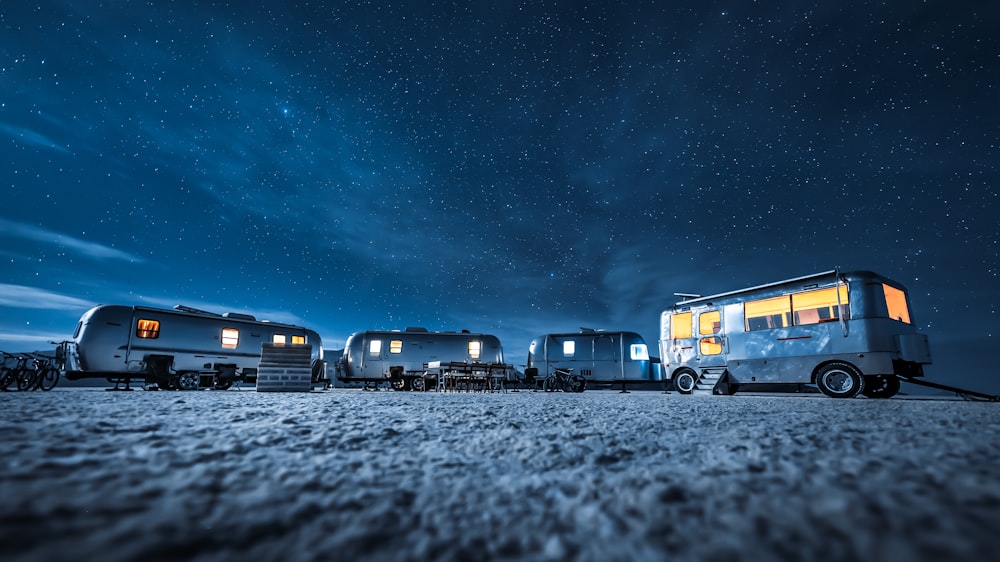 blue and white bus on road during night time