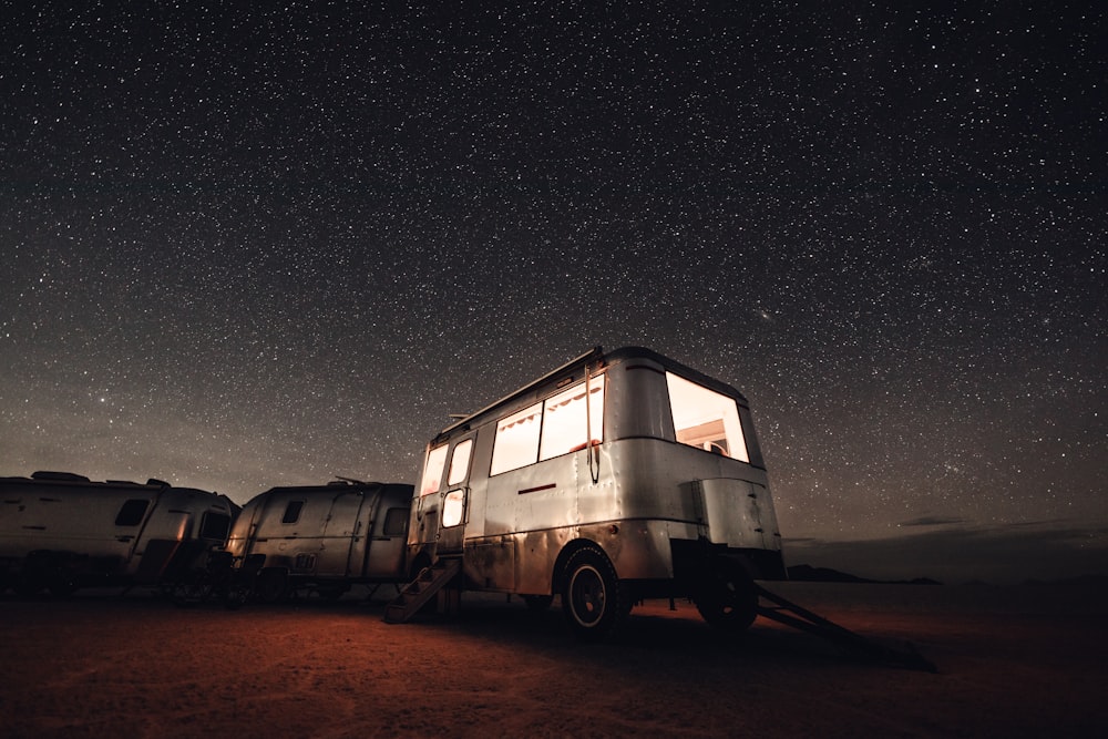 white and black van on brown sand during night time