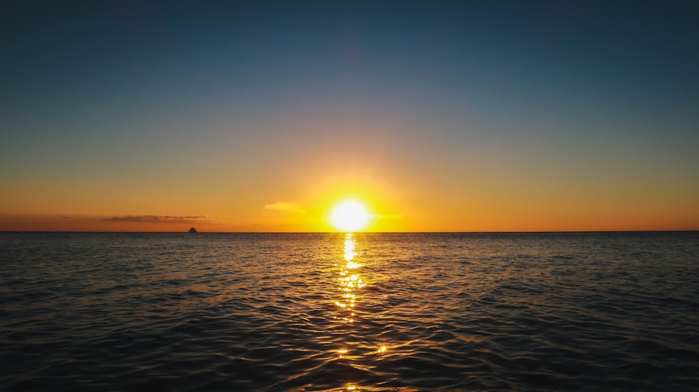 body of water during sunset