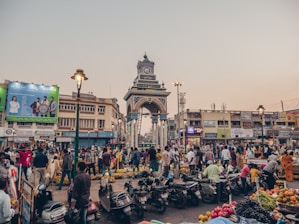 people sitting on black motorcycle near brown concrete building during daytime