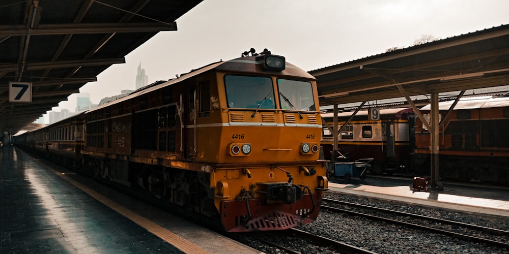 yellow and black train under white sky during daytime