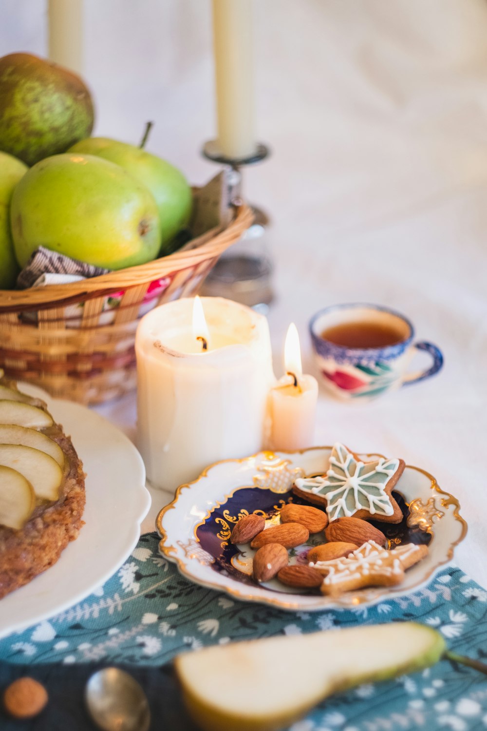 green apple fruit on white ceramic plate beside brown cookies on brown woven basket