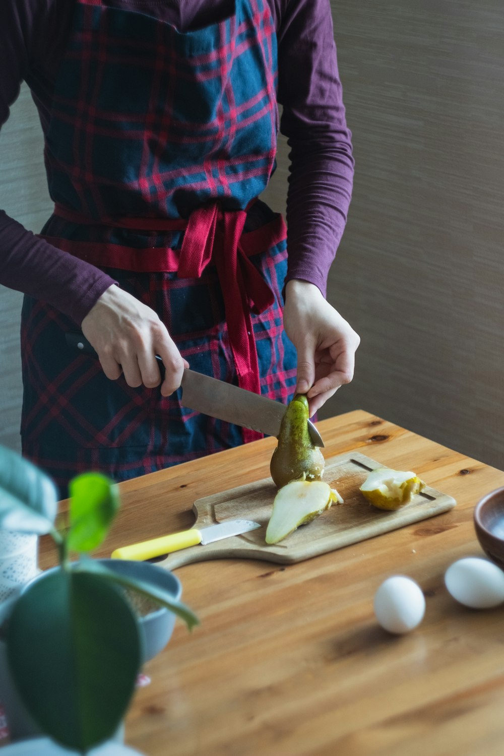 person holding brown wooden chopping board