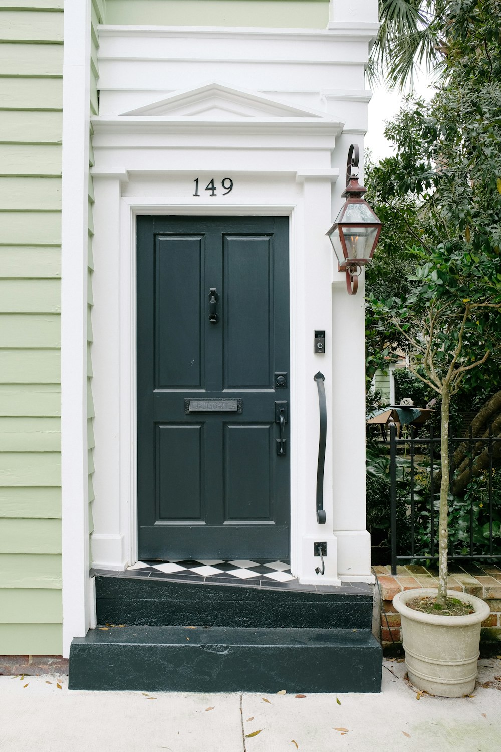 white wooden door with green plants