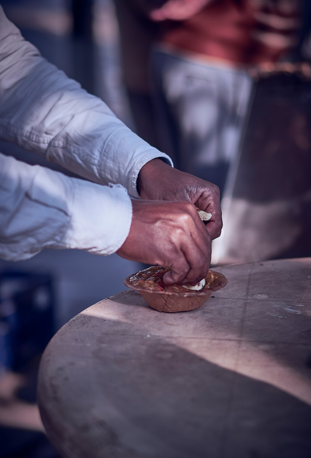 person in white dress shirt holding brown wooden chopping board