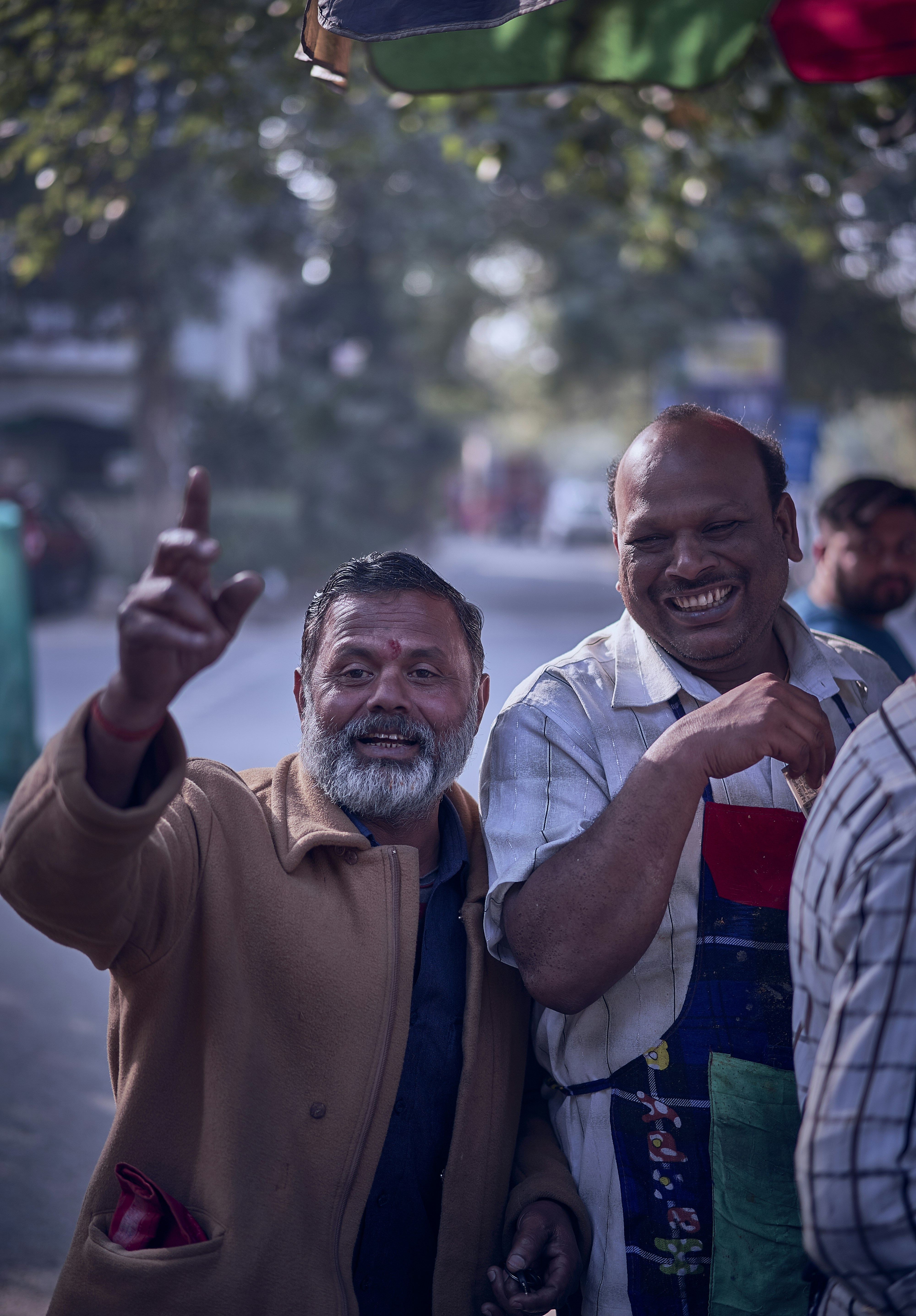 man in brown sweater smiling