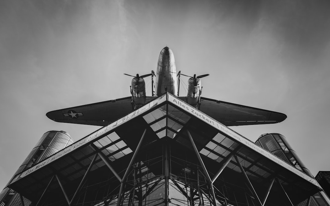 grayscale photo of airplane in mid air