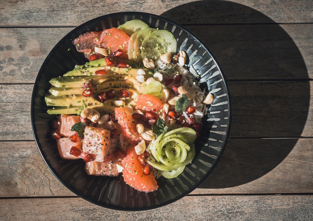 vegetable salad on black round plate