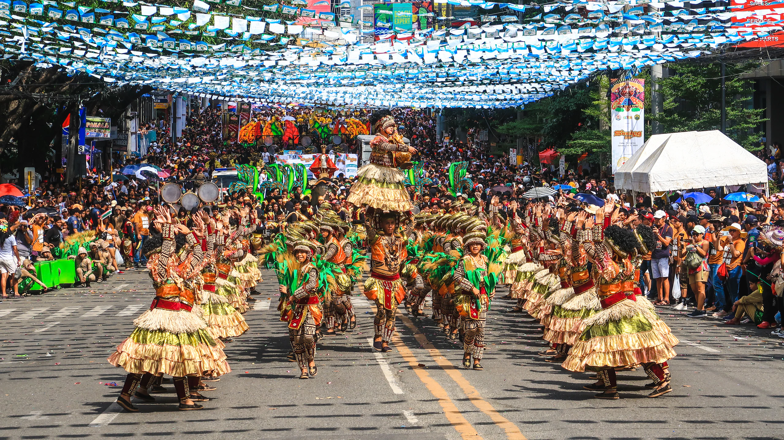 Festival dancers in traditional costume on a street in Cebu