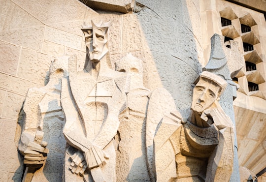 man in coat concrete statue in La Sagrada Familia Spain