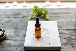 brown glass bottle on brown wooden table