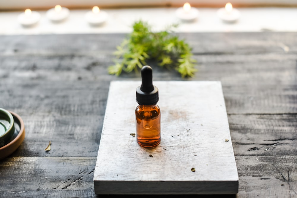 brown glass bottle on brown wooden table