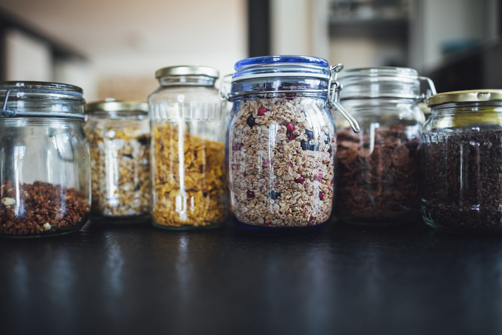 brown and white beans in clear glass jar