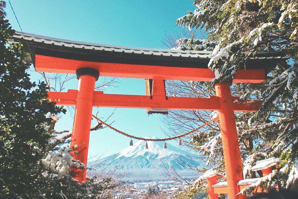 red metal frame with snow covered mountain in distance