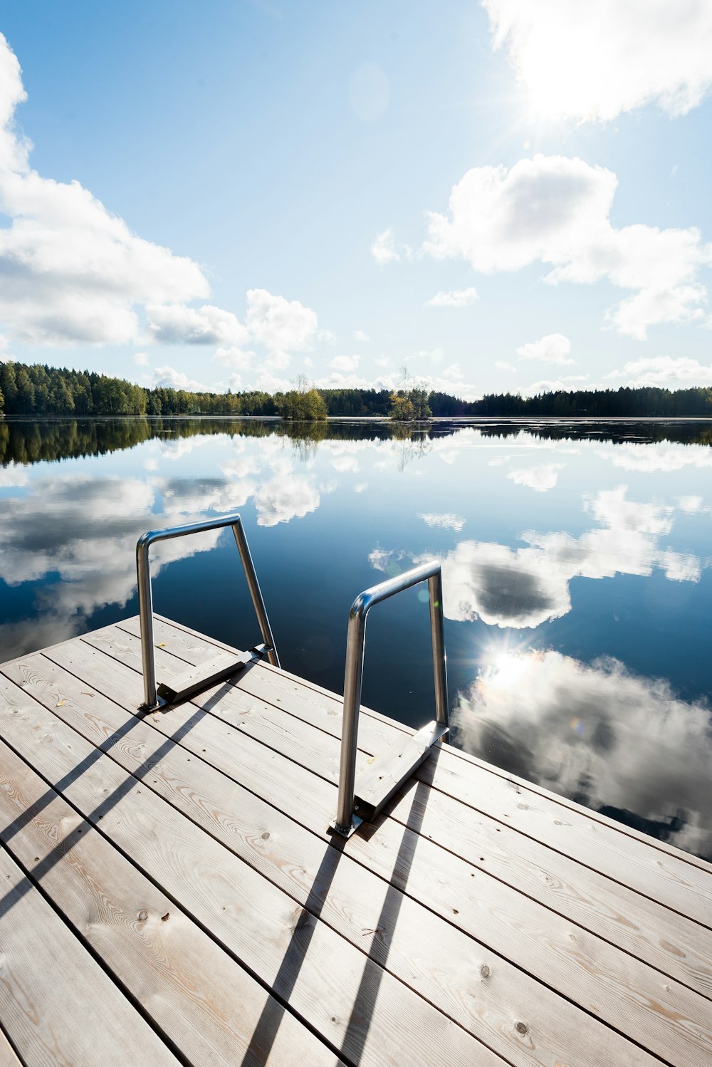 brown wooden dock over body of water during daytime