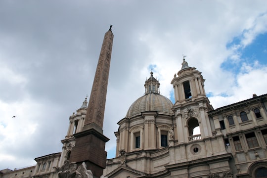 brown concrete building under cloudy sky during daytime in Piazza Navona Italy