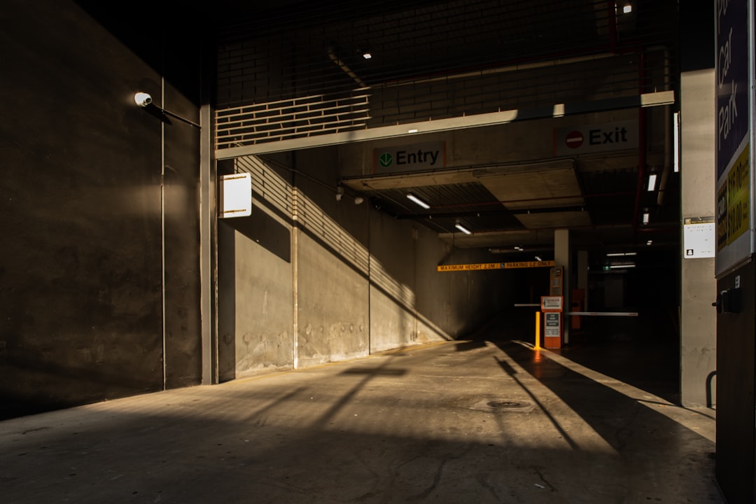 gray concrete building with brown wooden bench