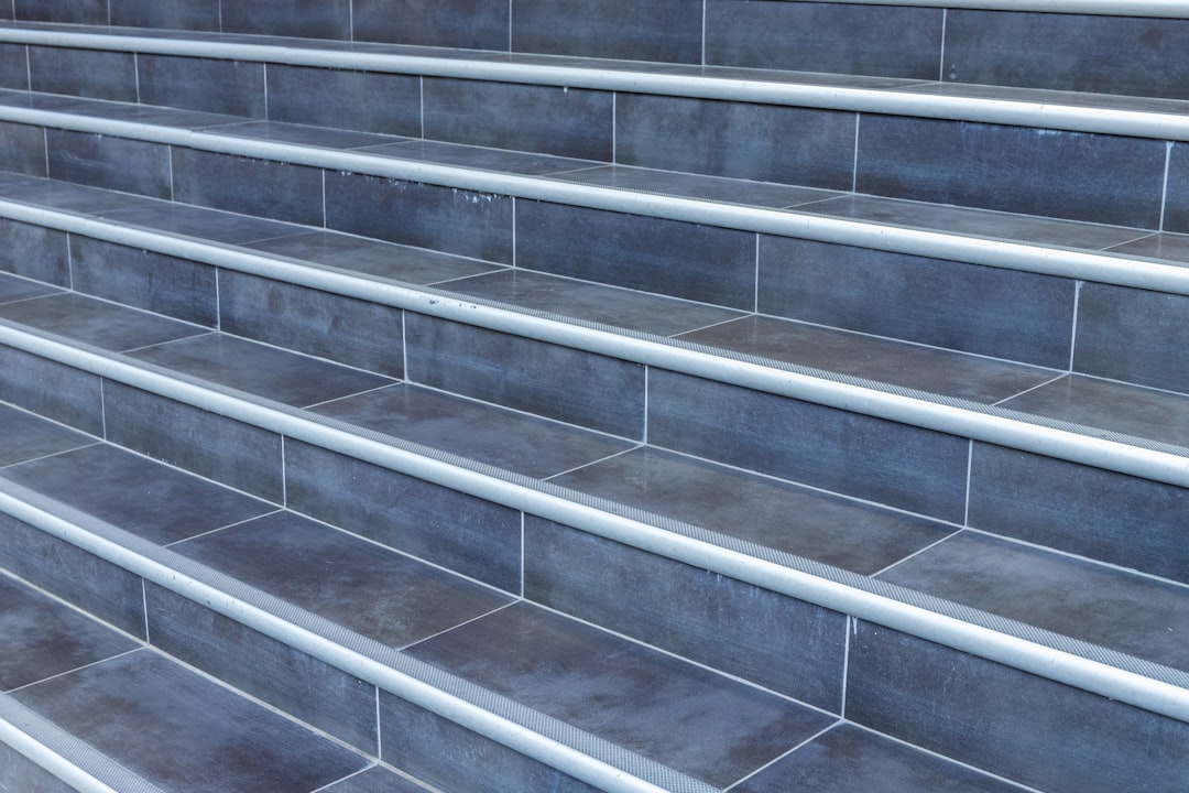 gray concrete staircase with stainless steel railings