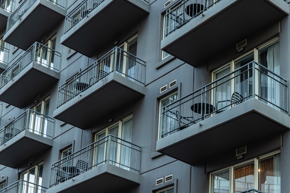 white concrete building with white metal railings