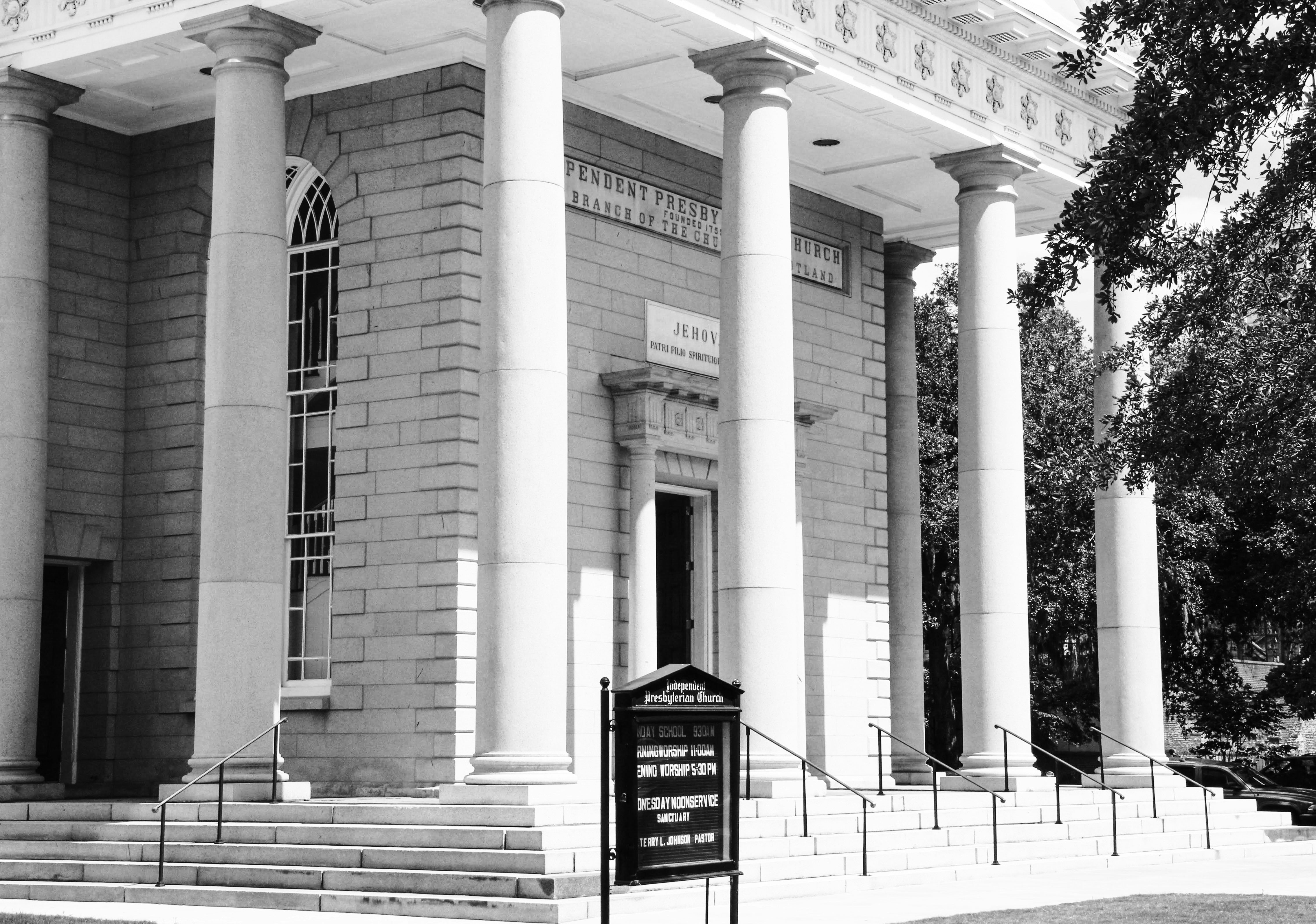 grayscale photo of building with black and white signage
