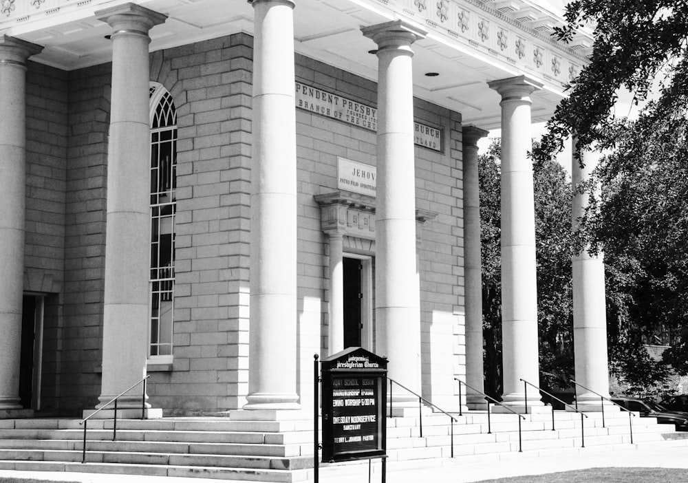 grayscale photo of building with black and white signage