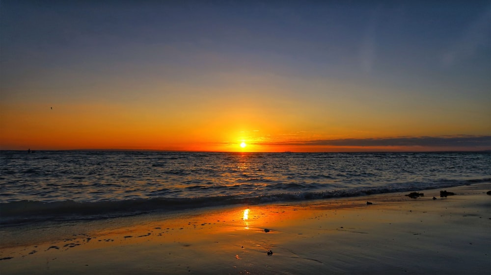 body of water during sunset