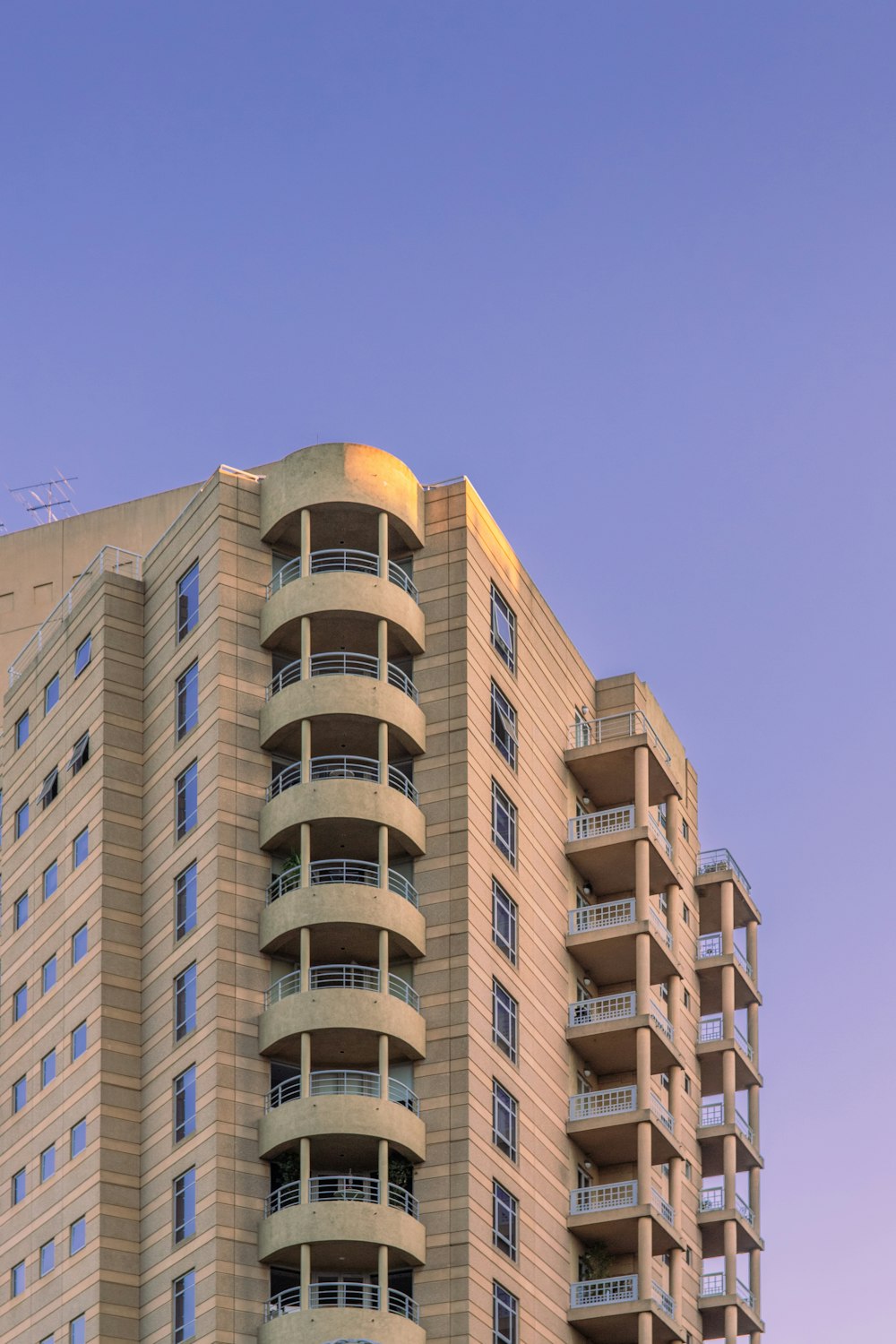 brown and white concrete building under blue sky during daytime